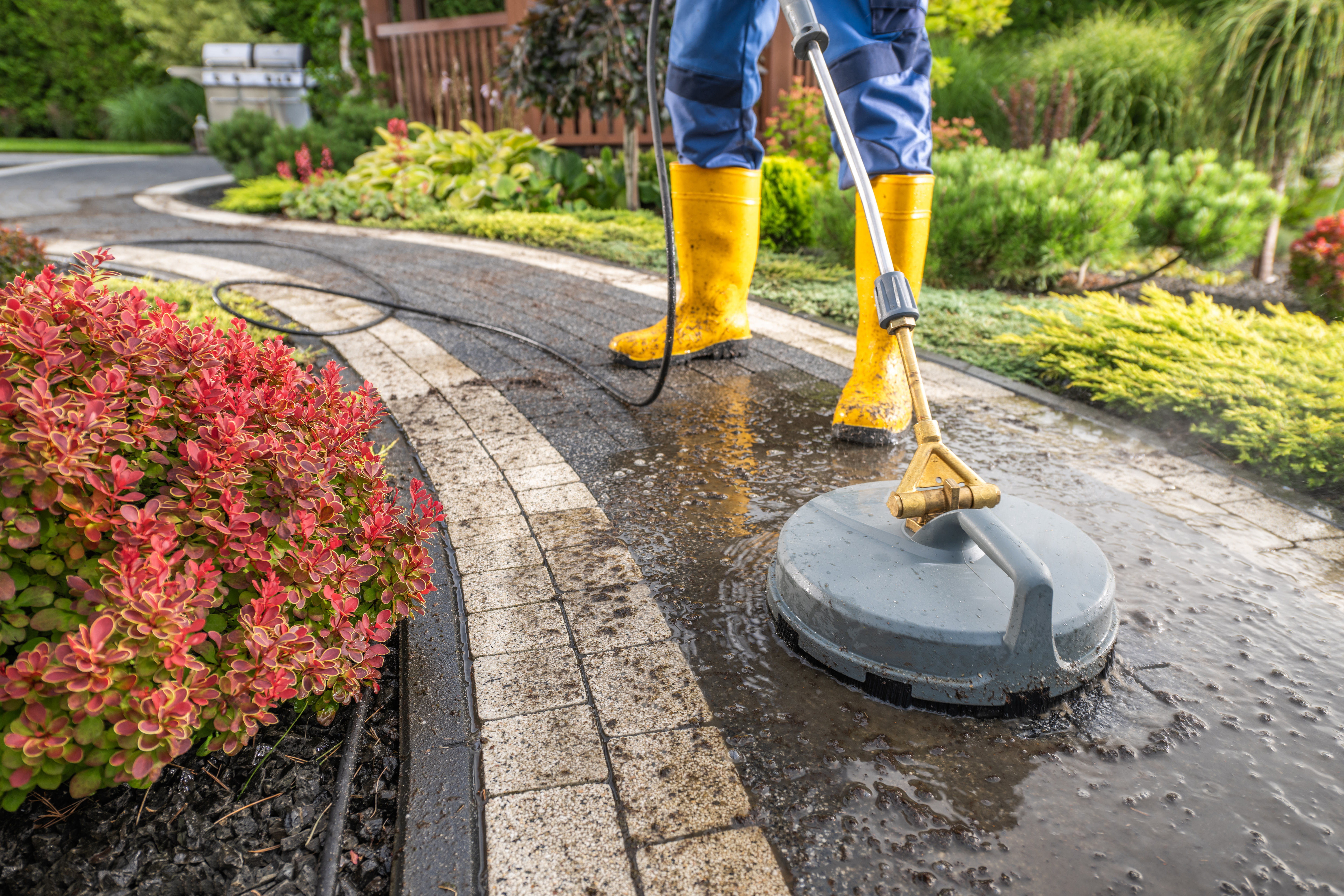 vecteezy_garden-worker-pressure-washing-decorative-bricks-garden-paths_31686672.jpg
