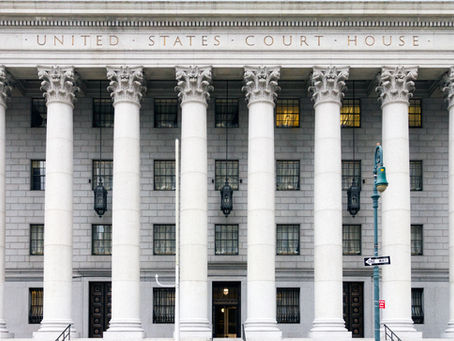 United States courthouse with large columns and federal courthouse inscription.