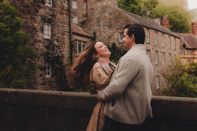 Cinematic destination couple photoshoot in Dean Village, romantic travel photography for couples visiting Edinburgh.