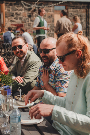 Wedding guests during drinks reception at Comrie Croft captured by a Scotland wedding photographer.