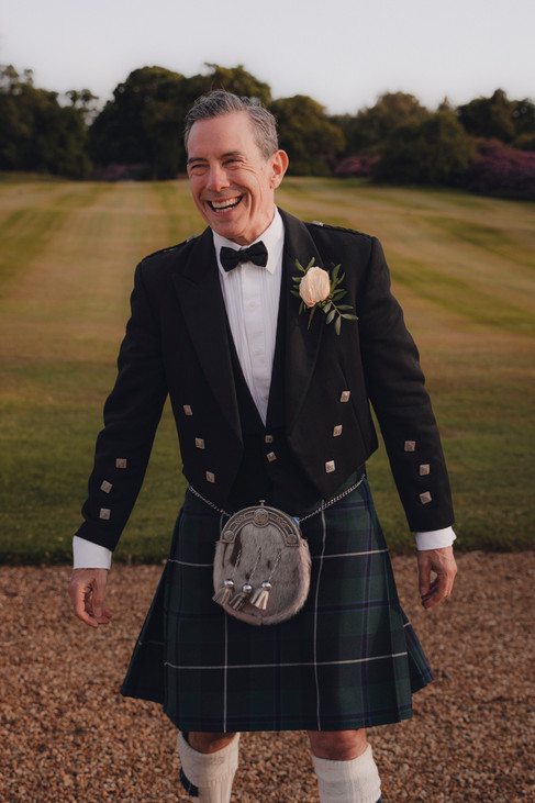 Romantic portrait of couple by the castle gates, natural and meaningful Scotland wedding photography.