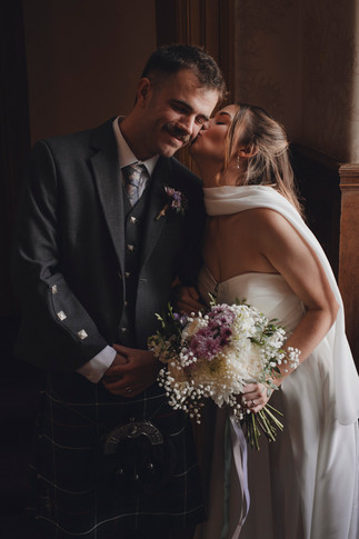 Bride and groom portrait on staircase at Edinburgh City Chambers, cinematic and romantic wedding photography.