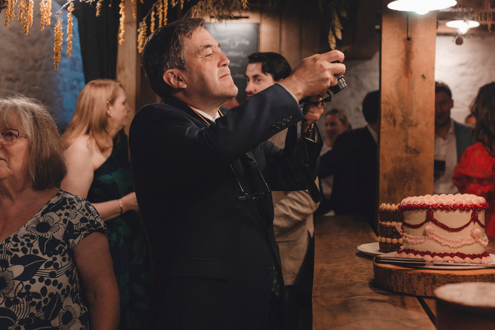 Bride and groom cutting the wedding cake at The Free Company, Balerno – editorial Scotland wedding photography.