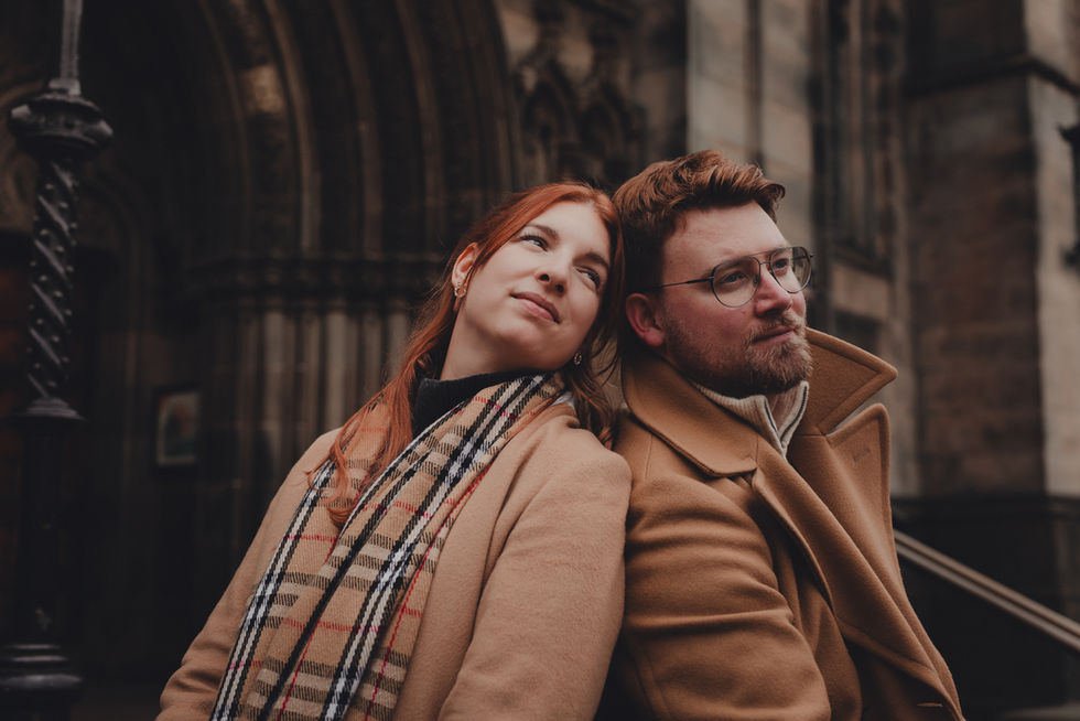 Cinematic romantic couple session in Edinburgh during Christmas, set among the historic Old Town and Calton Hill with festive winter atmosphere.