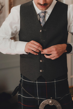 Documentary style groom preparation at an Edinburgh apartment before City Chambers ceremony