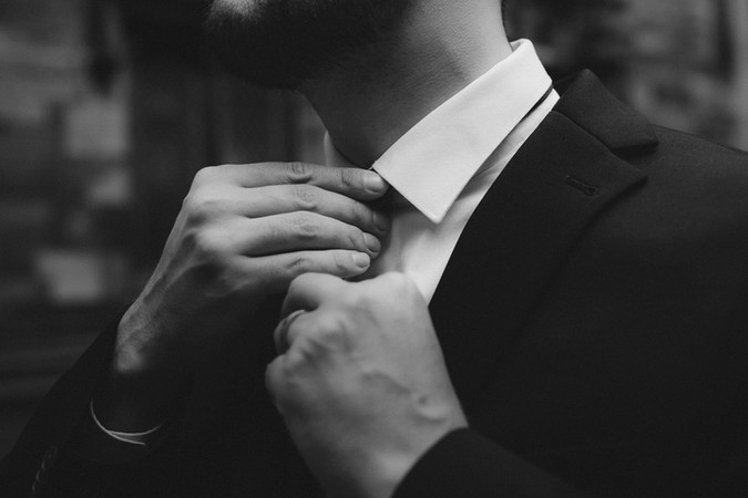 Intimate wedding elopement photographed in front of the majestic walls of New College, Edinburgh, capturing romance and connection.