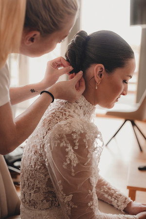 Bride laughing with bridesmaids during wedding preparations at Forbes of Kingennie