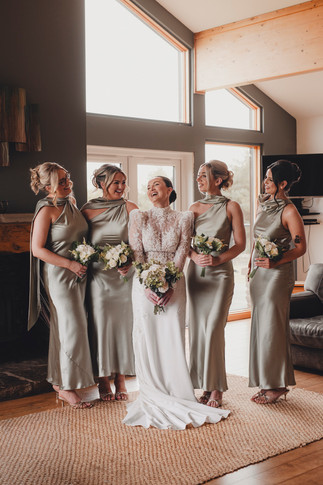 Bride preparing for ceremony surrounded by bridesmaids at Forbes of Kingennie