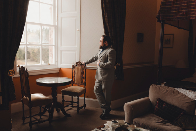 Groom getting ready inside Dalhousie Castle Scotland romantic elopement
