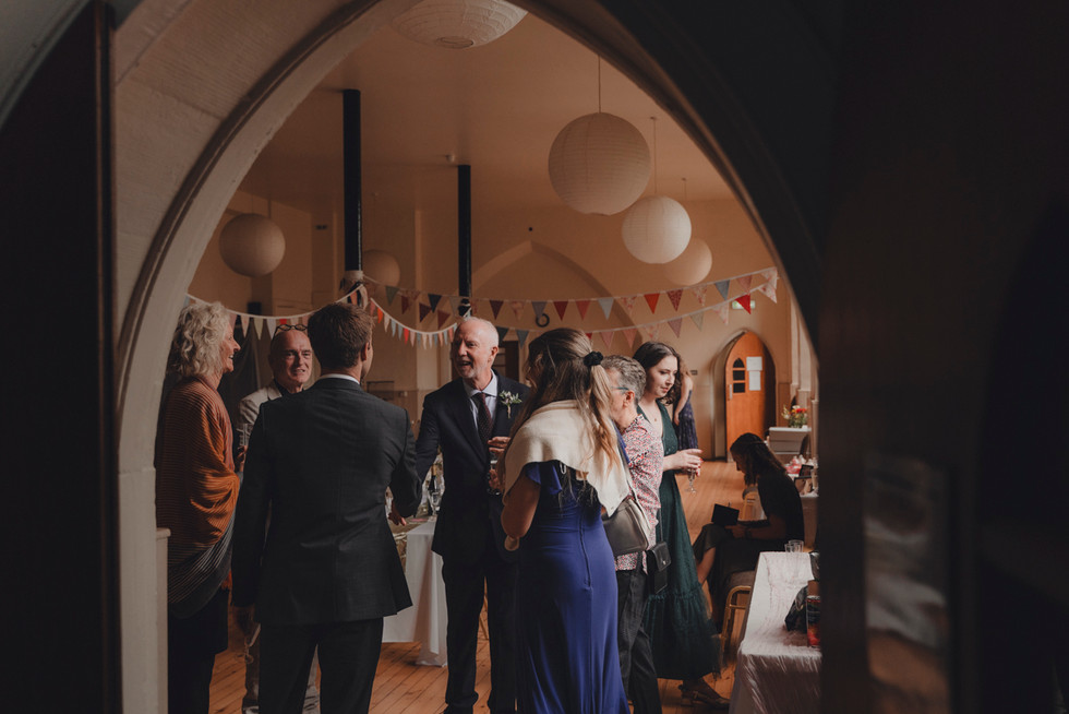 Bride and groom enjoying drinks reception with friends and family at St Columba’s, Edinburgh