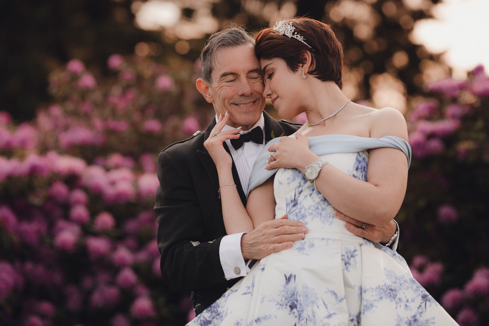Romantic portrait of couple by the castle gates, natural and meaningful Scotland wedding photography.