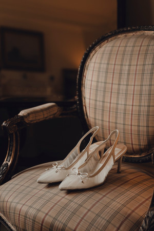 Detail shots of shoes, jewelry, and makeup during meaningful bridal preparation