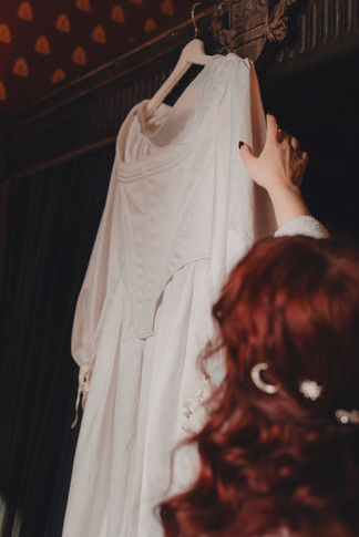 Bride putting on her bohemian wedding dress at Dalhousie Castle Scotland elopement
