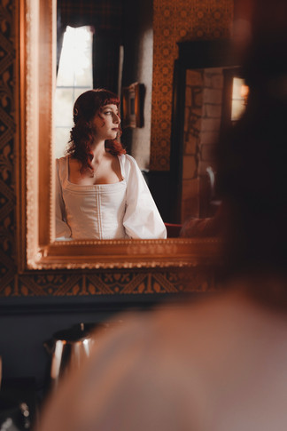 Bridal details including flowing dress and accessories photographed in romantic castle setting