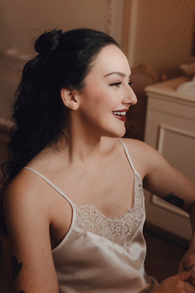 Bride putting on her dress in flat light, captured with fine art and editorial style Edinburgh wedding photography