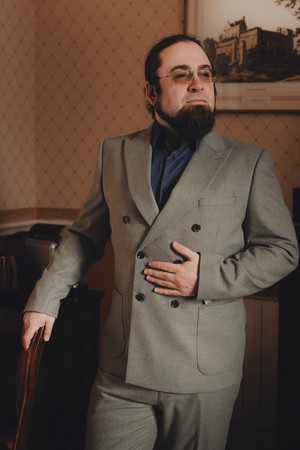 Groom holding ceremonial sword before Dalhousie Castle elopement ceremony