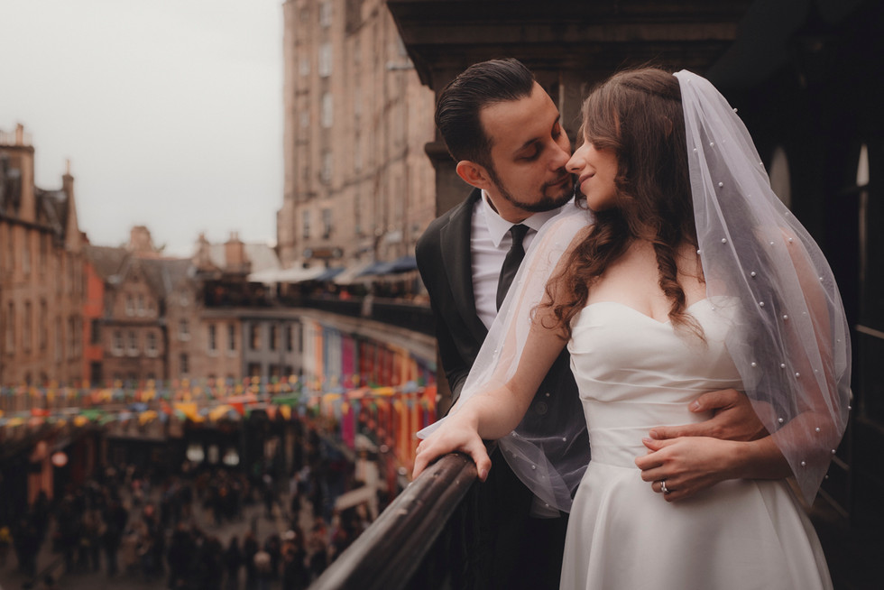 Edinburgh wedding photographer capturing a romantic elopement along the vibrant Victorian buildings of Victoria Street.