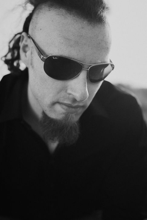 Professional beach photoshoot of a musician, artistic portrait with natural light for music promotion and personal branding.