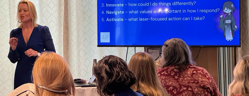 Mehalah Beckett delivering a workshop on success saboteurs and leadership mindset to a room of business leaders.