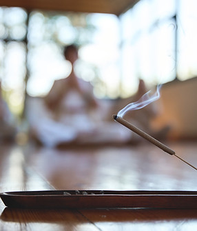 Scented stick on a wooden stand holder Burning aromatic incense smoky stick with meditatin