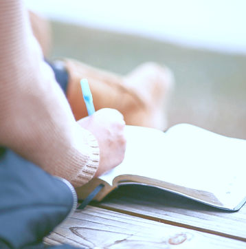 close-up photography of person writing o
