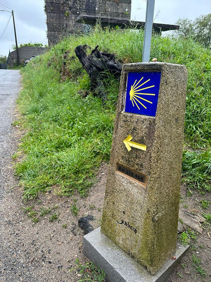 a yellow arrow on a stone plinth