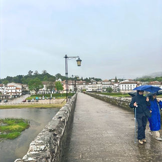 A rainy day looking across a bridge.