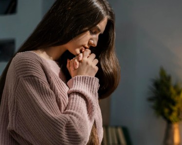 Free photo side view of woman praying