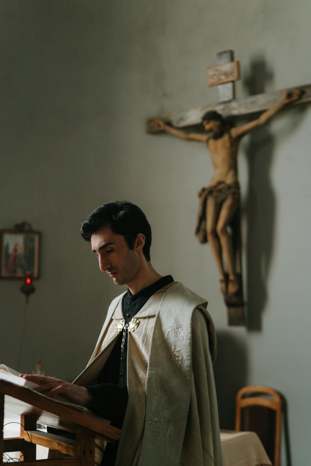photo of a priest reading