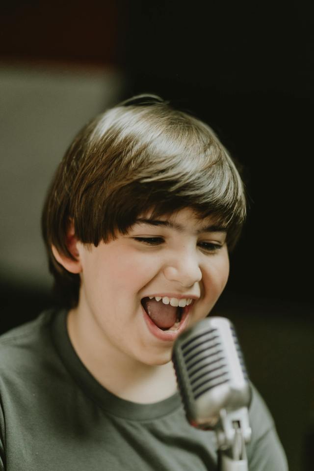 boy singing on the microphone