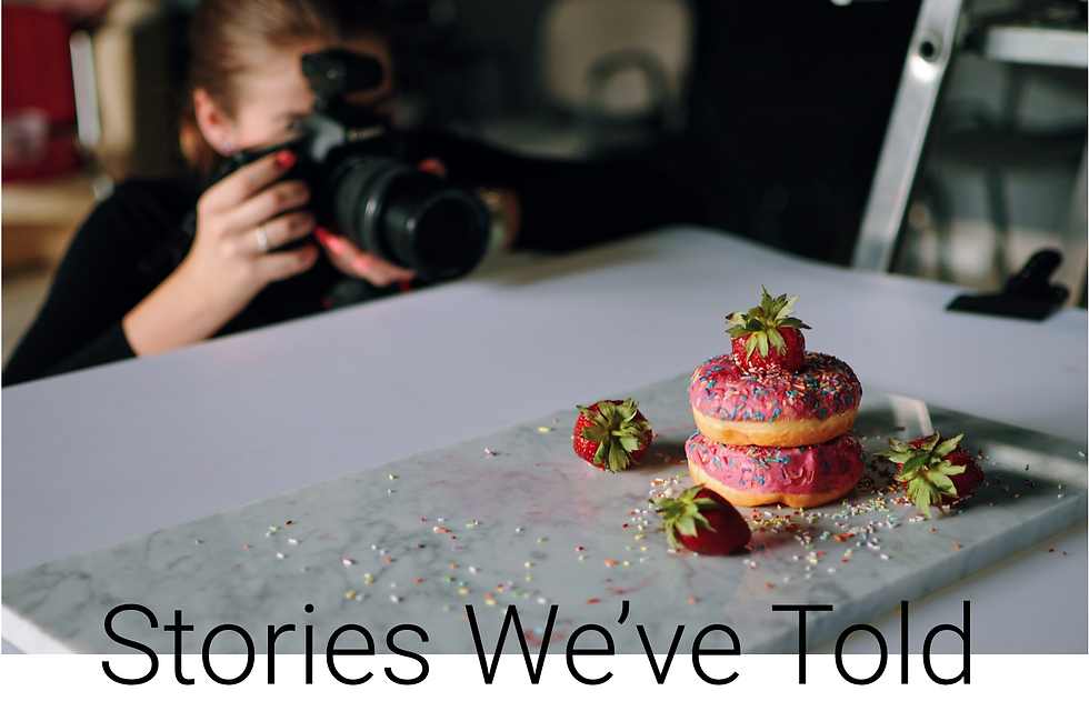 Woman photographing an image of donuts with the text Stories We've Told.