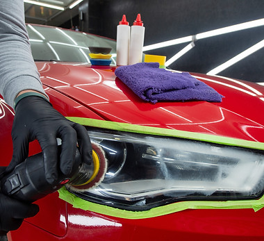 Headlight polishing Adhesive tape on car headlights Detailing car outside.jpg