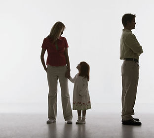 Image of a Family with a Child Between Two Parents Description: "Silhouette of a family with parents standing apart and a child between them symbolizes the challenges of family dynamics and relationships. This image highlights the practice's expertise in managing family and relationship conflicts, fostering healthier connections."