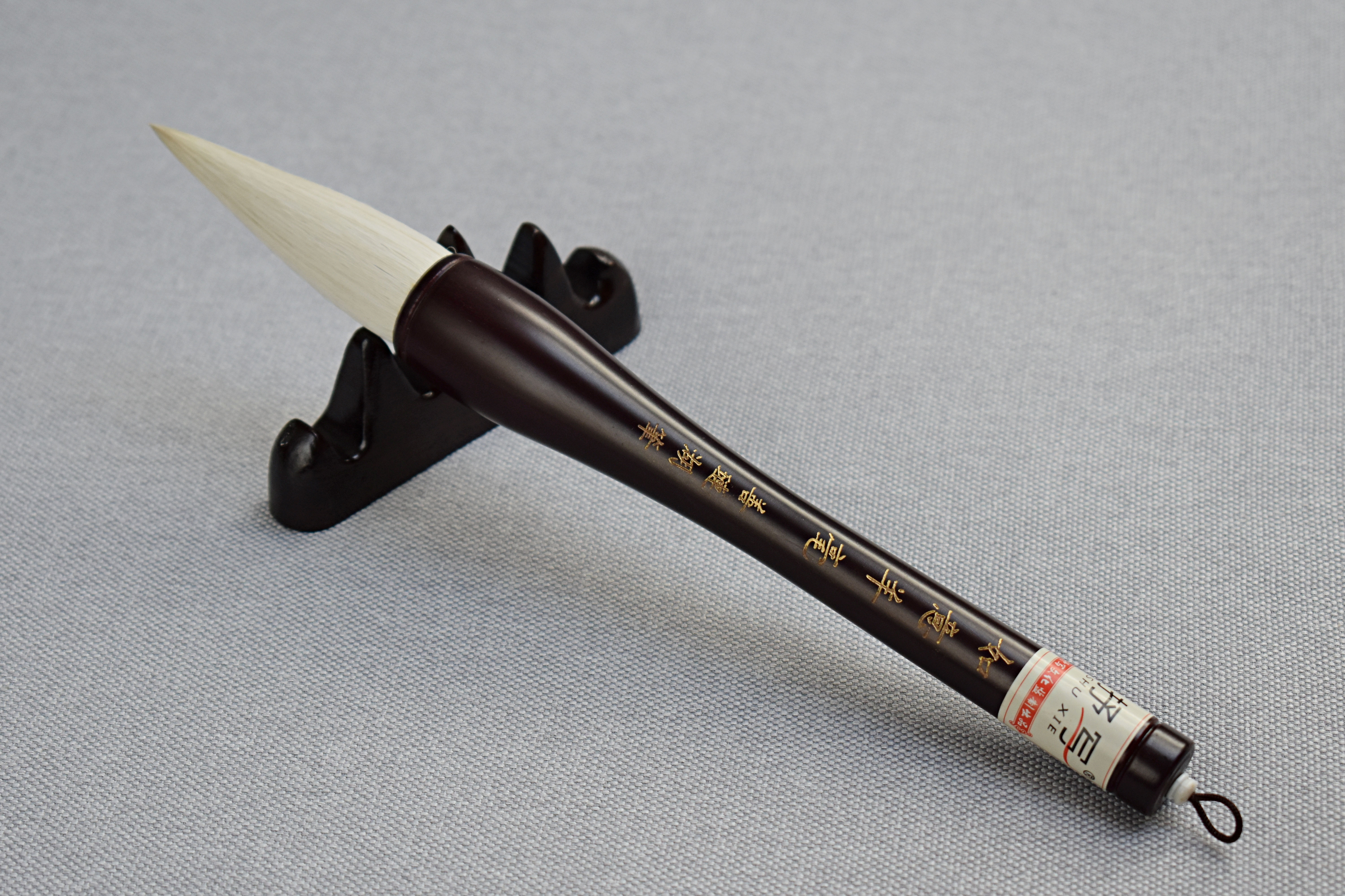 PREMIUM A large burgundy brush made of wood and goat hair