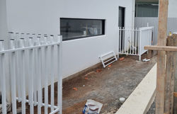 Pool fencing ready for artificial turf installation.