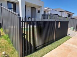 Aluminium bladed panels with custom fabricated rake panel ane gate in monument colour at 1.5m