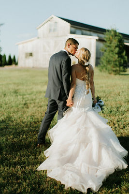 Bride and groom standing outdoors with the barn in the background at Cedar Hills Farm wedding venue near Chattanooga, Tennessee