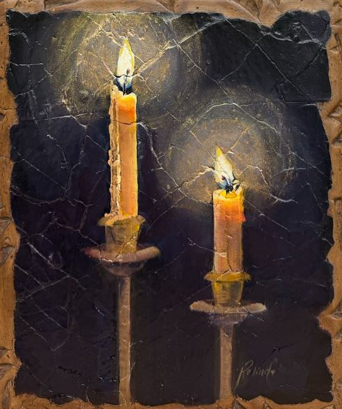 Two candles burning in darkness