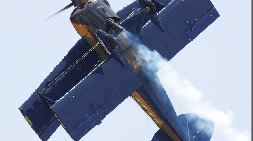 Patrick McAlee flying his Pitts S1S inverted in a vertical aerobatic climb with smoke trailing behind.