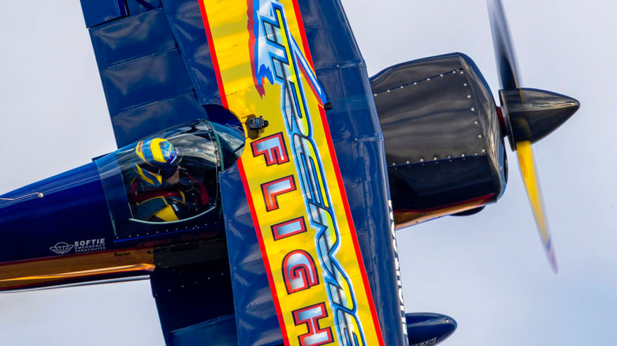 Top view of Patrick McAlee’s Pitts S1S during an inverted aerobatic maneuver at an airshow.