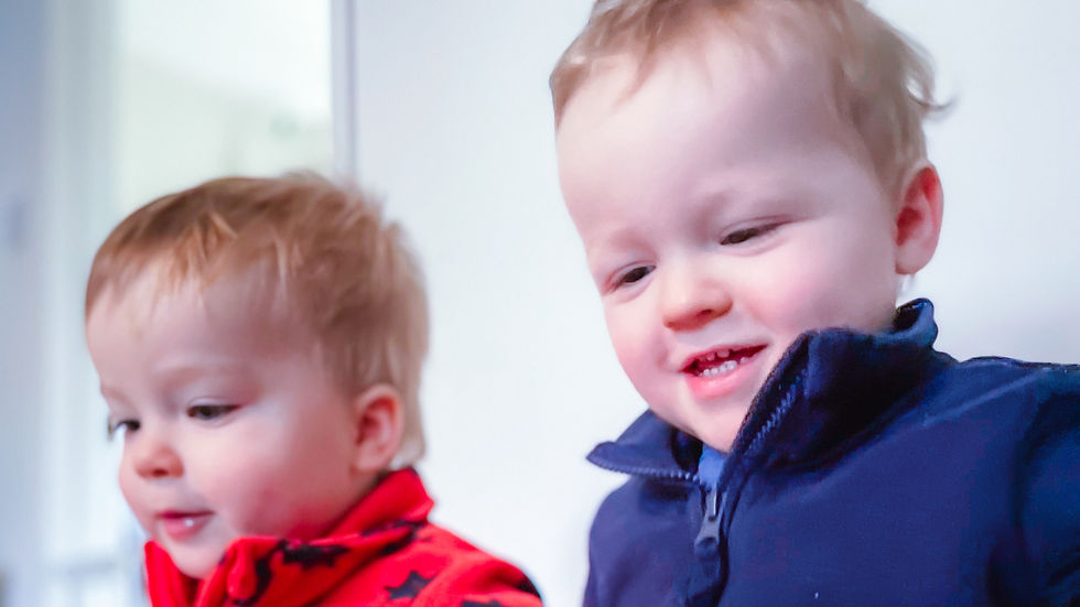 High angle view of cribs with sleeping twins