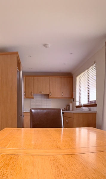 Dining area with open plan kitchen in a 3 bedroom villa at Kilconquhar Castle Estate.