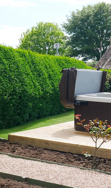 Rose Cottage exterior with private hot tub and outdoor seating area at Kilconquhar Castle Estate, a dog-friendly property near St Andrews and the Fife coast.