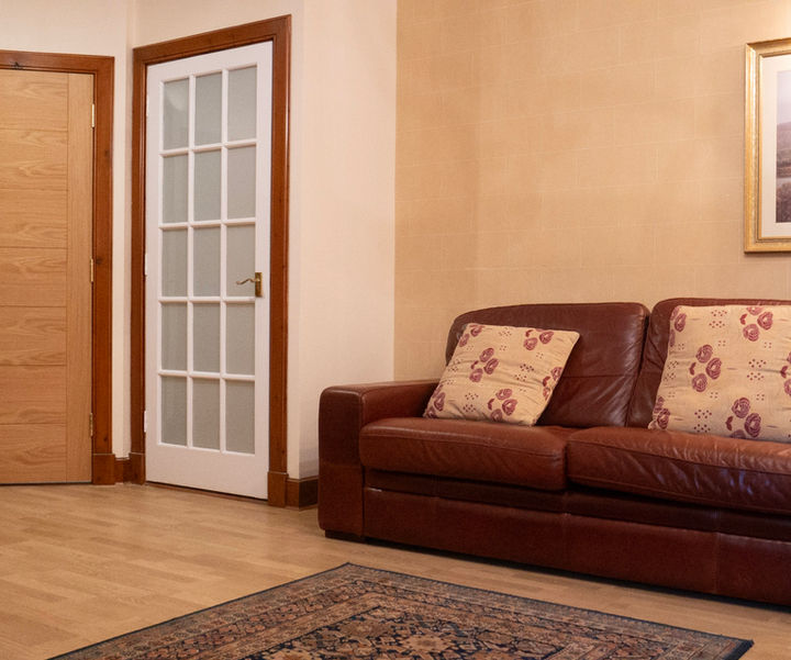 Family hotel room seating area with sofa and TV at Kilconquhar Castle Estate