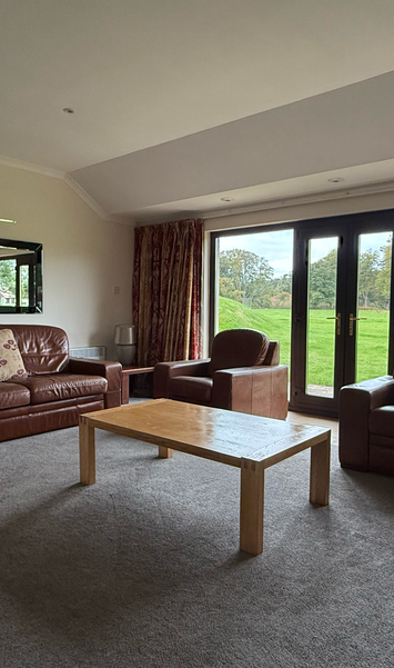 Spacious lounge with patio doors overlooking estate grounds in a 3 bedroom villa.