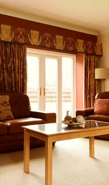 Lounge with patio doors opening to the garden at Pines Cottage in Fife