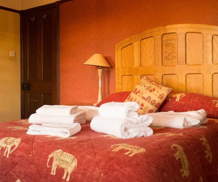 Double bedroom with fresh linen and towels at The Gate House cottage