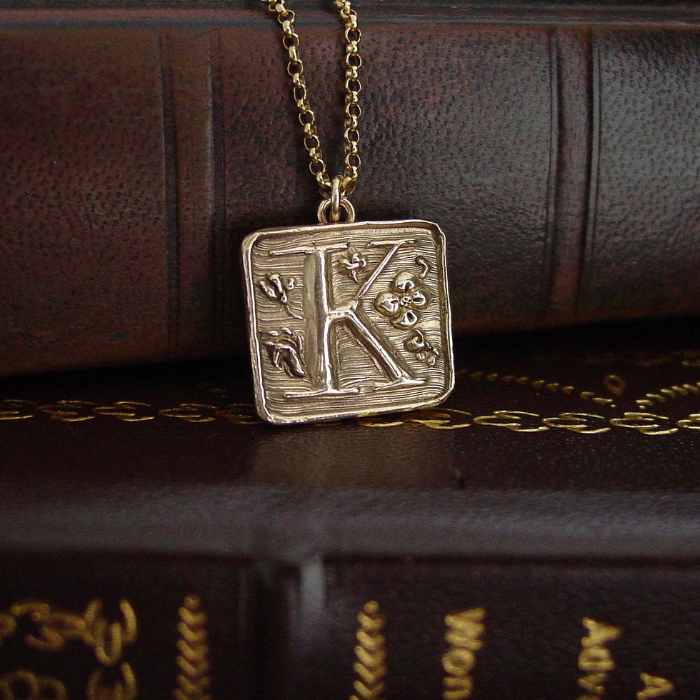 Thumbnail: K initial necklace on leather books