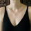 Thumbnail: Tiny Ouroboros necklace on woman