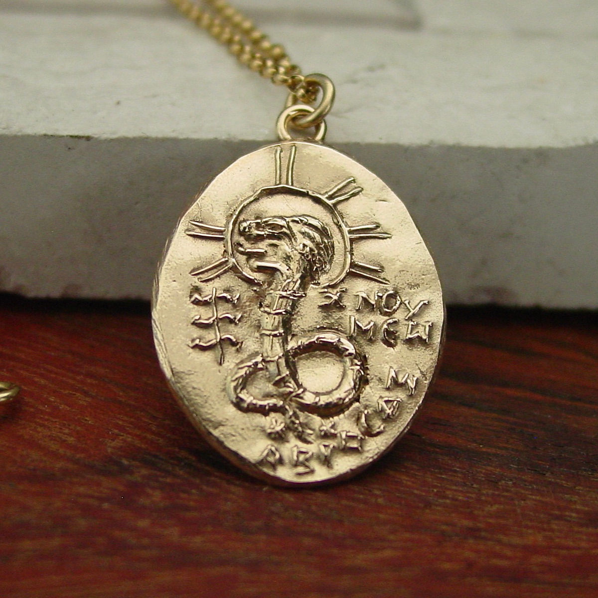 Gnostic lion serpent Chnoubis necklace close up